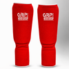 Red GRIP shin guards with “Never Give Up” logo on a white and grey background.